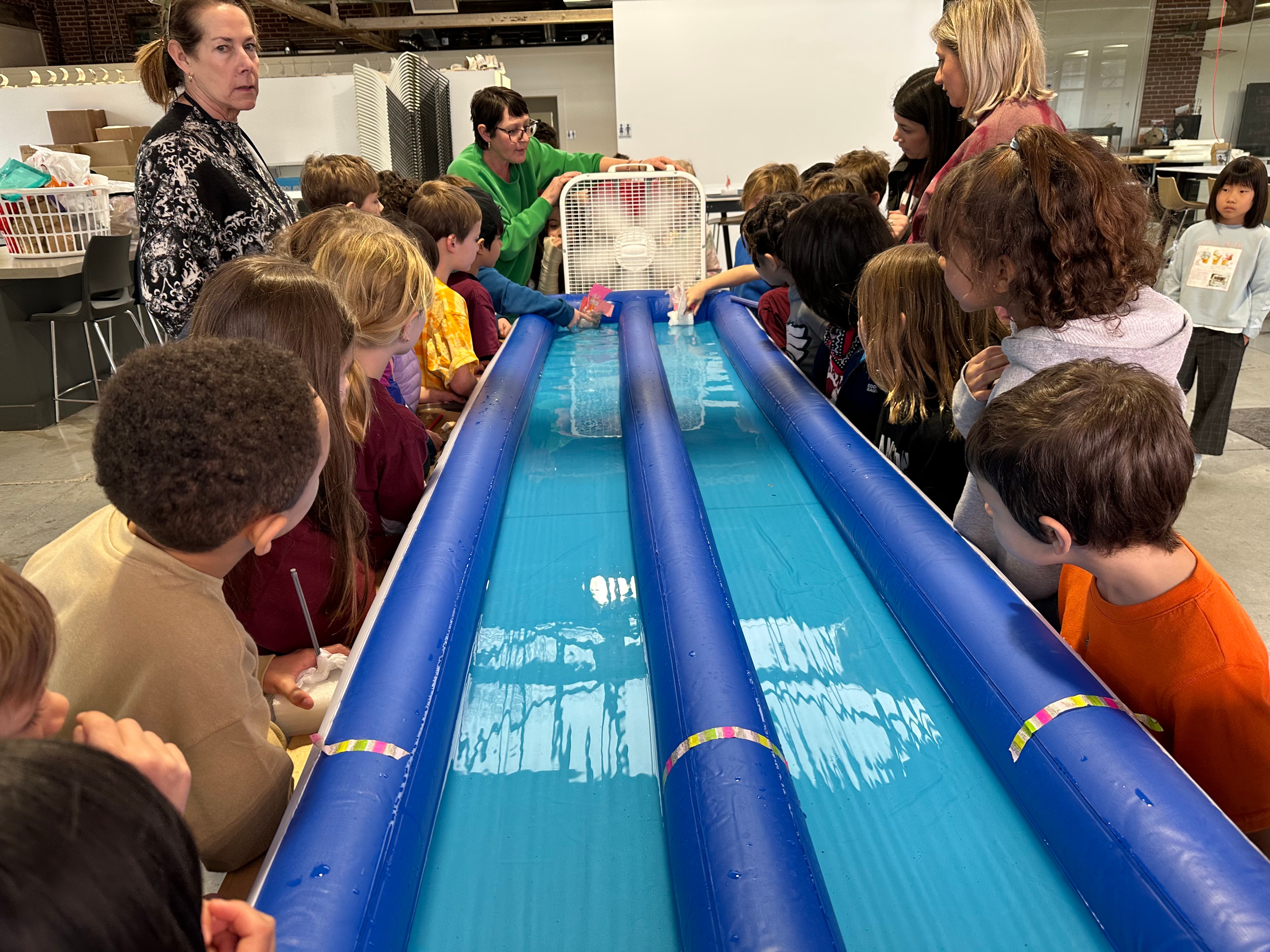 Students exploring a hands-on water engineering activity